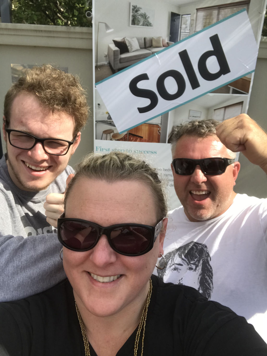 Vicki Williams with son Fred and husband Sam celebrating buying an apartment in Donald Street, Brunswick last year. Photo: Supplied