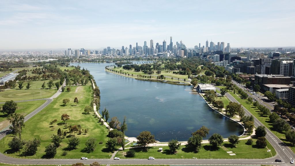 Aerial views of Albert Park Lake, Melbourne, with CBD skyline in the background.
