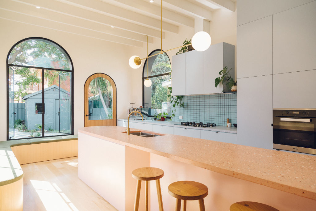 The most significant move to amplify space was to integrate the kitchen island and the dining table, and open up the rear wall of the existing house. Photo: Tash McCammon