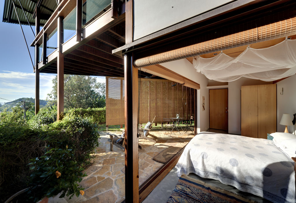 The main bedroom looks out at lush gardens. Photo: Michael Nicholson Photography