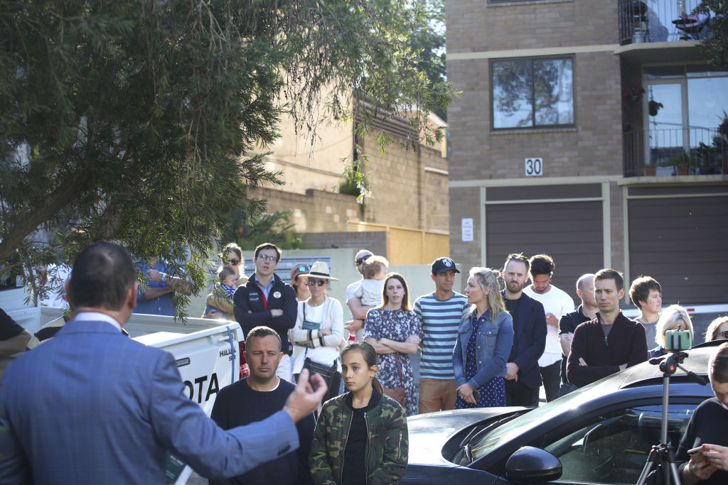 The crowd spilled out onto Grove St to watch the Lilyfield cottage go under the hammer. Photo: James Alcock