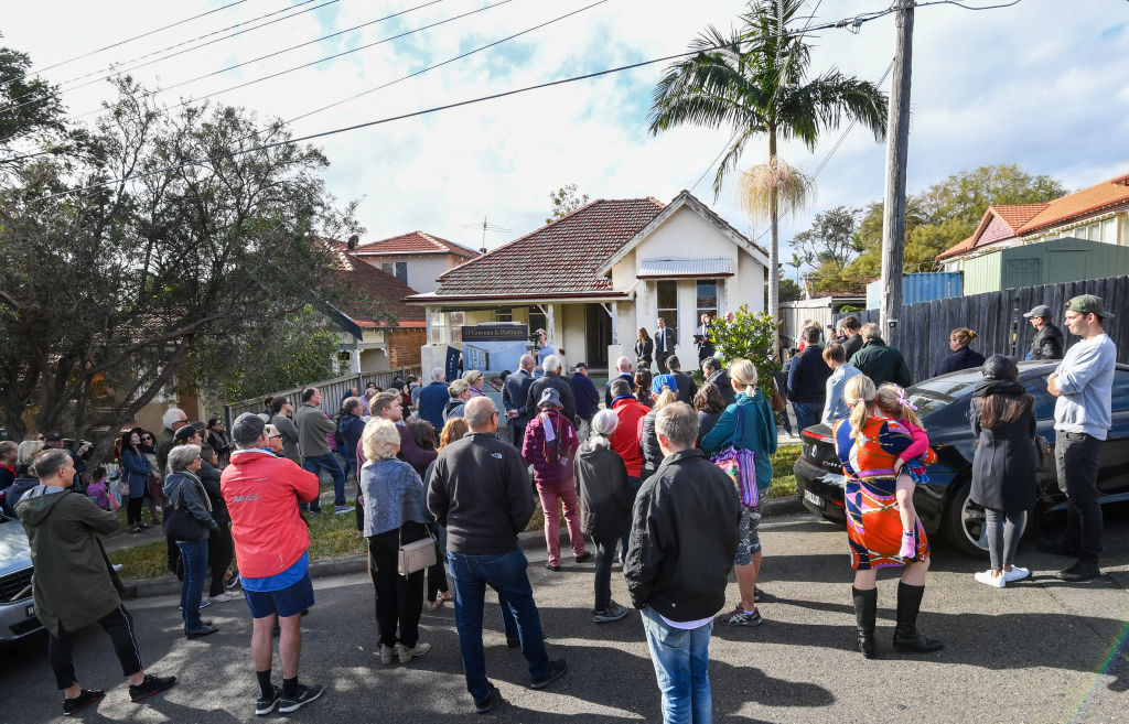 A large crowd gathered to watch 28 Lang St in Mosman go under the hammer for the first time in 40 years. Photo: Peter Rae