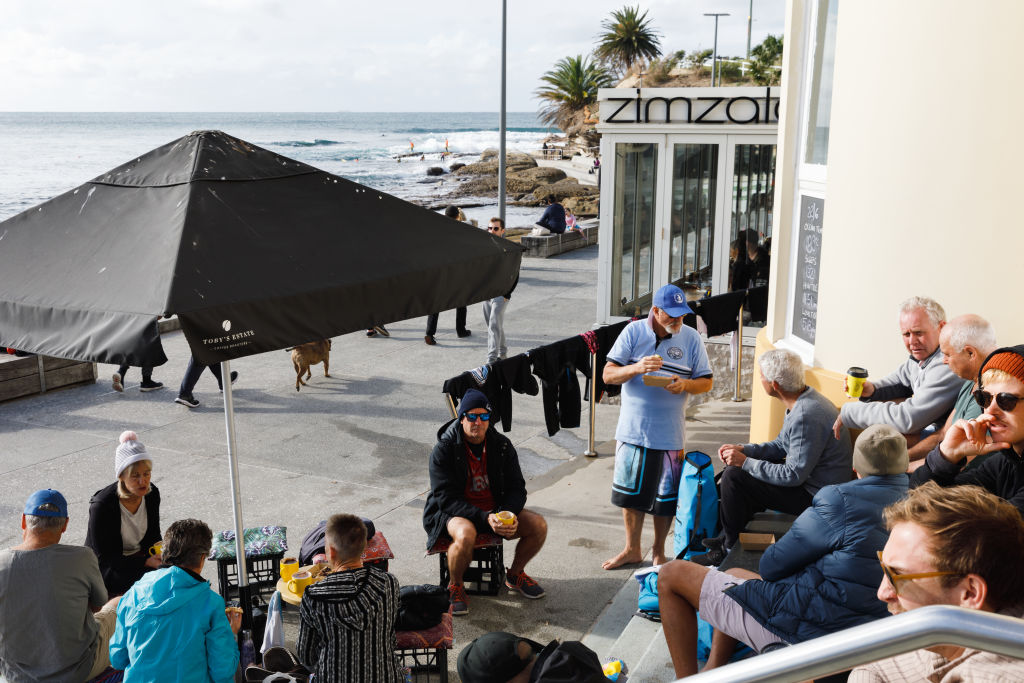 Patrons enjoying a morning coffee outside Barefoot On The Beach Cafe near Cronulla Surf Club. Photo: Steven Woodburn