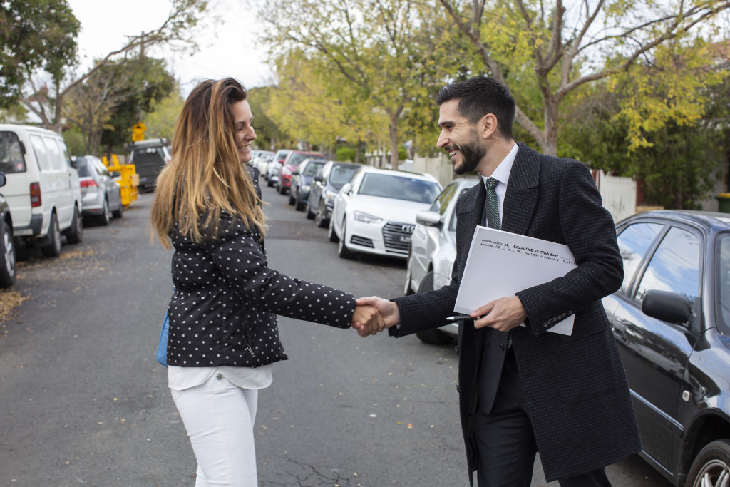 Robert Pierantozzi shakes hands with the winning bidder. Photo: Stephen McKenzie