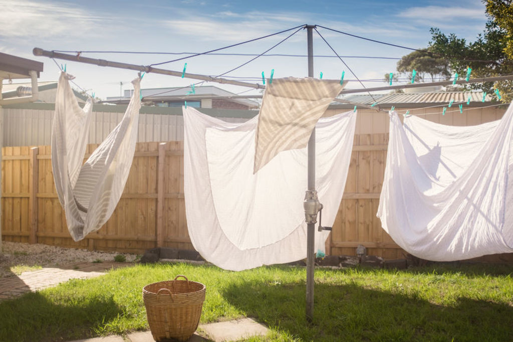 Hanging out the washing is a great opportunity to move your body and get some fresh air. Photo: Stocksy