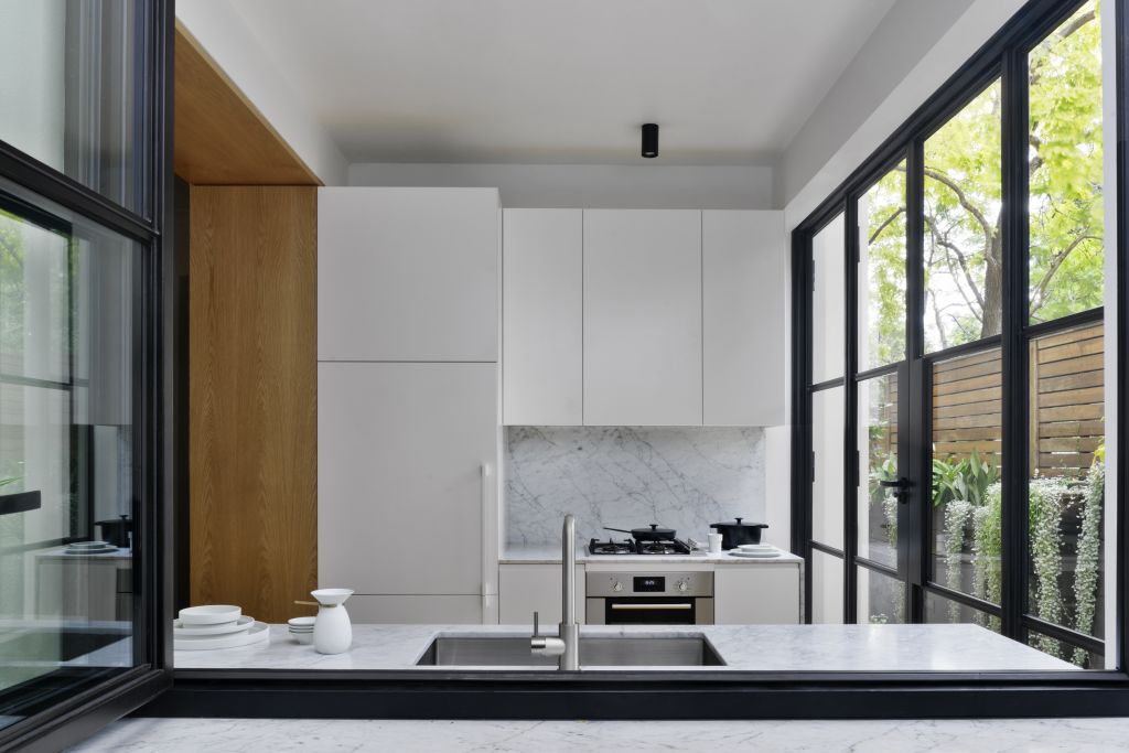 The marble bench and splashback grab attention. Photo: Justin Alexander