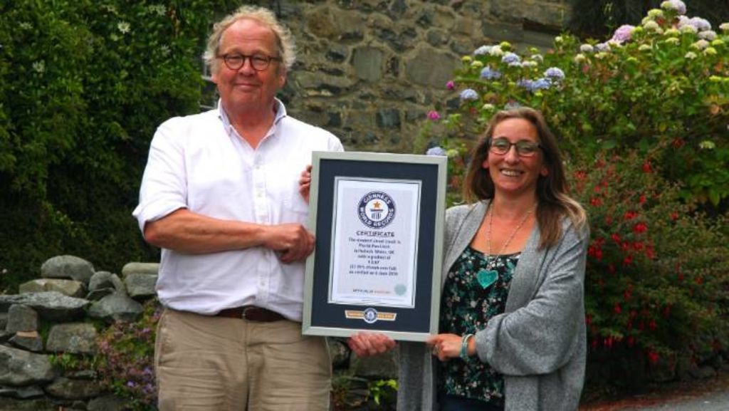 Co-administrators Gwyn Headley and Sarah Badham with the Guinness World Records Certificate for Ffordd Pen Llech as the World's Steepest Street.
