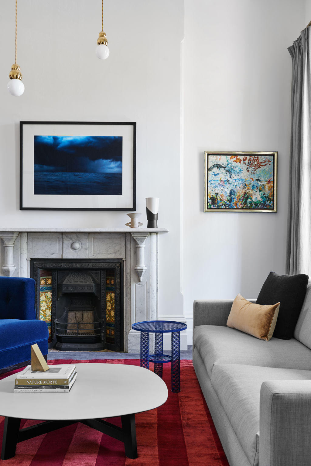 Simple forms in the original rooms, including the home’s existing fireplace, offer a sense of calm.  Photo: Dan Hocking