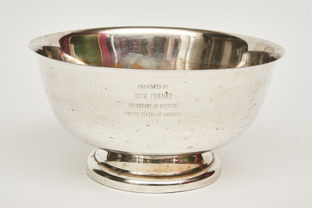 There is a silver bowl inscribed 'Presented by Dick Cheney Secretary of Defence, United States of America' priced between $500 and $700.