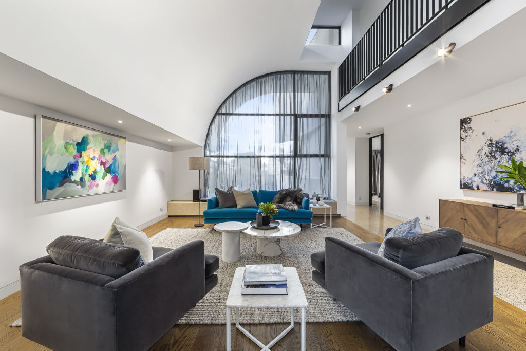 The floor to ceiling windows with sweeping sheer curtains add to the luxury of this home. Photo: Buxton.