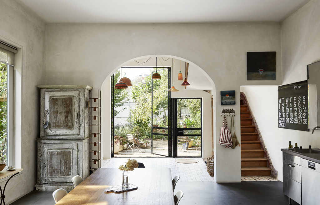 Looking through the dining room out to the garden. Lamps in distance by PET Lamp from Safari Living. Washed blue cabinet from Manon bis. Styling: Annie Portelli. Photo: Caitlin Mills