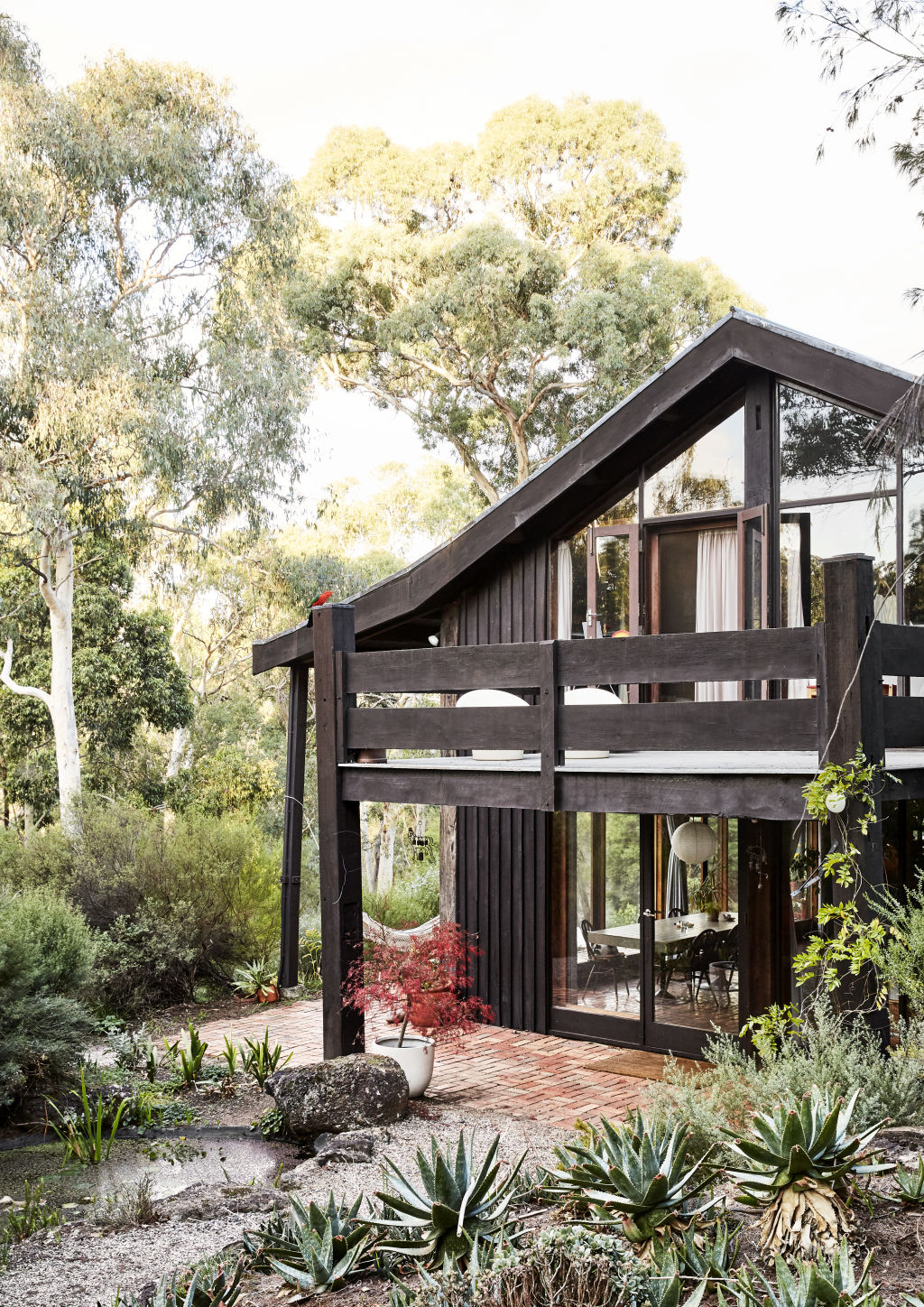 The property is surrounded by trees. Styling: Annie Portelli. Photo: Caitlin Mills