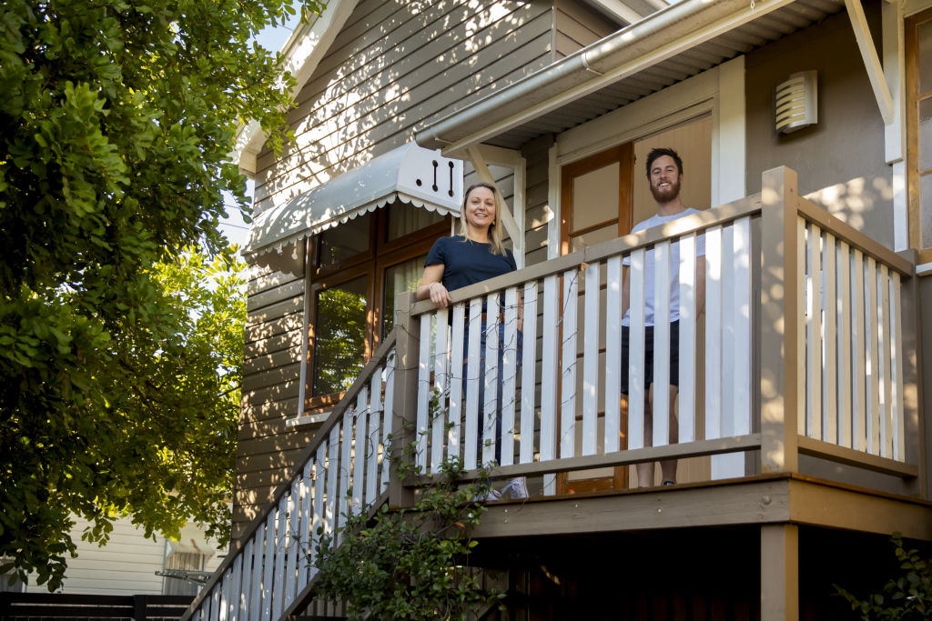 Caz Sydenham and Kyle Shepherd outside the front of the Queenslander home they bought together at Woolloongabba. Photo: Tammy Law