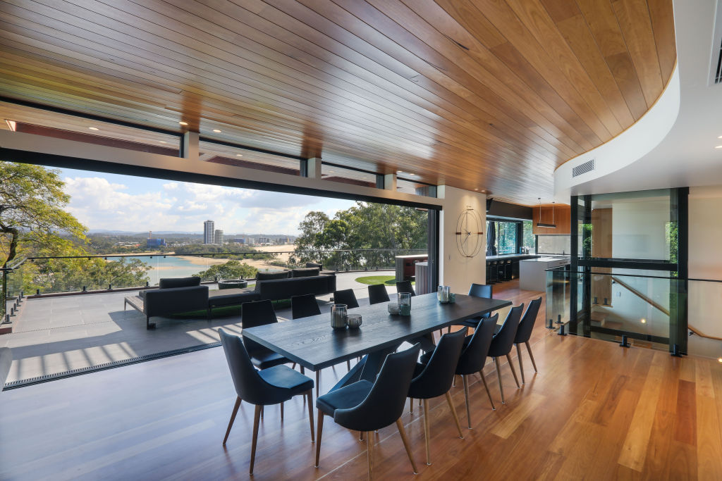 This open-plan living-dining area flows out to a spacious deck. Photo: Supplied