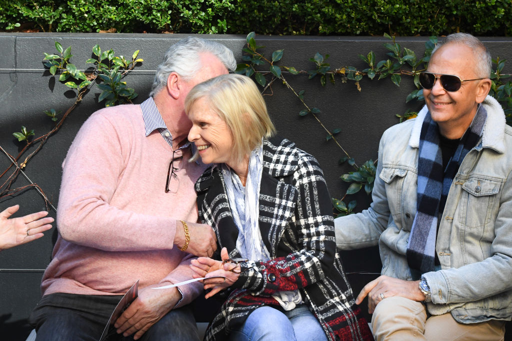 The happy buyer, (middle) is congratulated by friends. Photo: Peter Rae