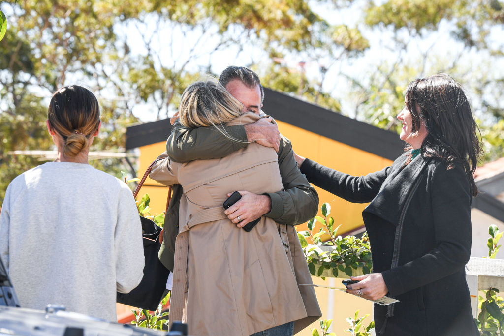 The winning bidders embrace after the fall of the hammer. Photo: Peter Rae