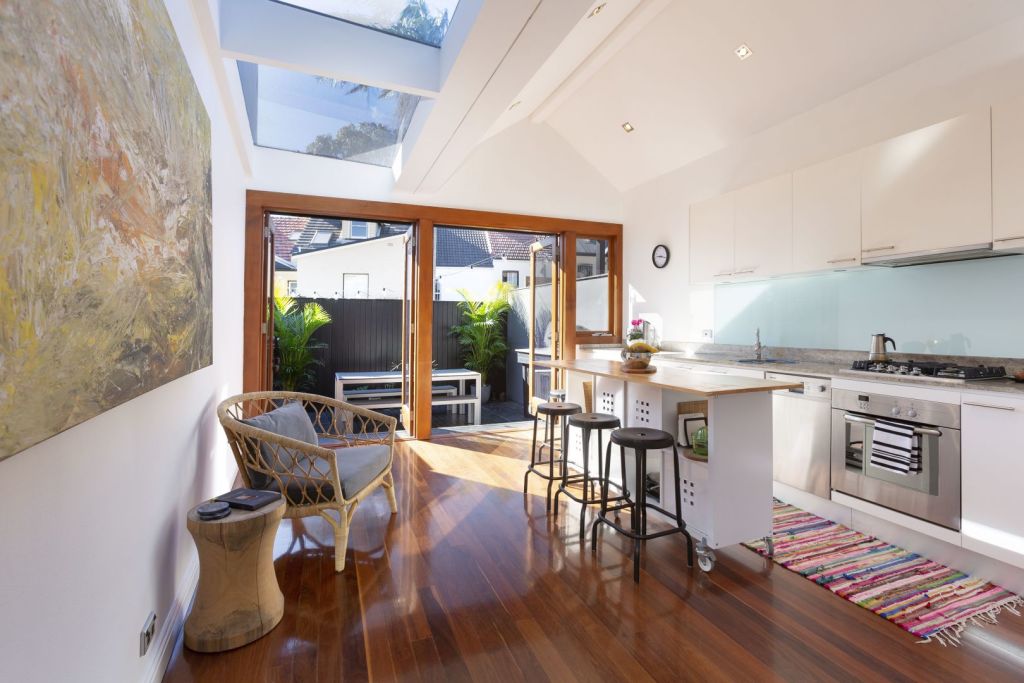 Large bifold or sliding doors coupled with skylights floods a terrace with light and brings the outdoors in.