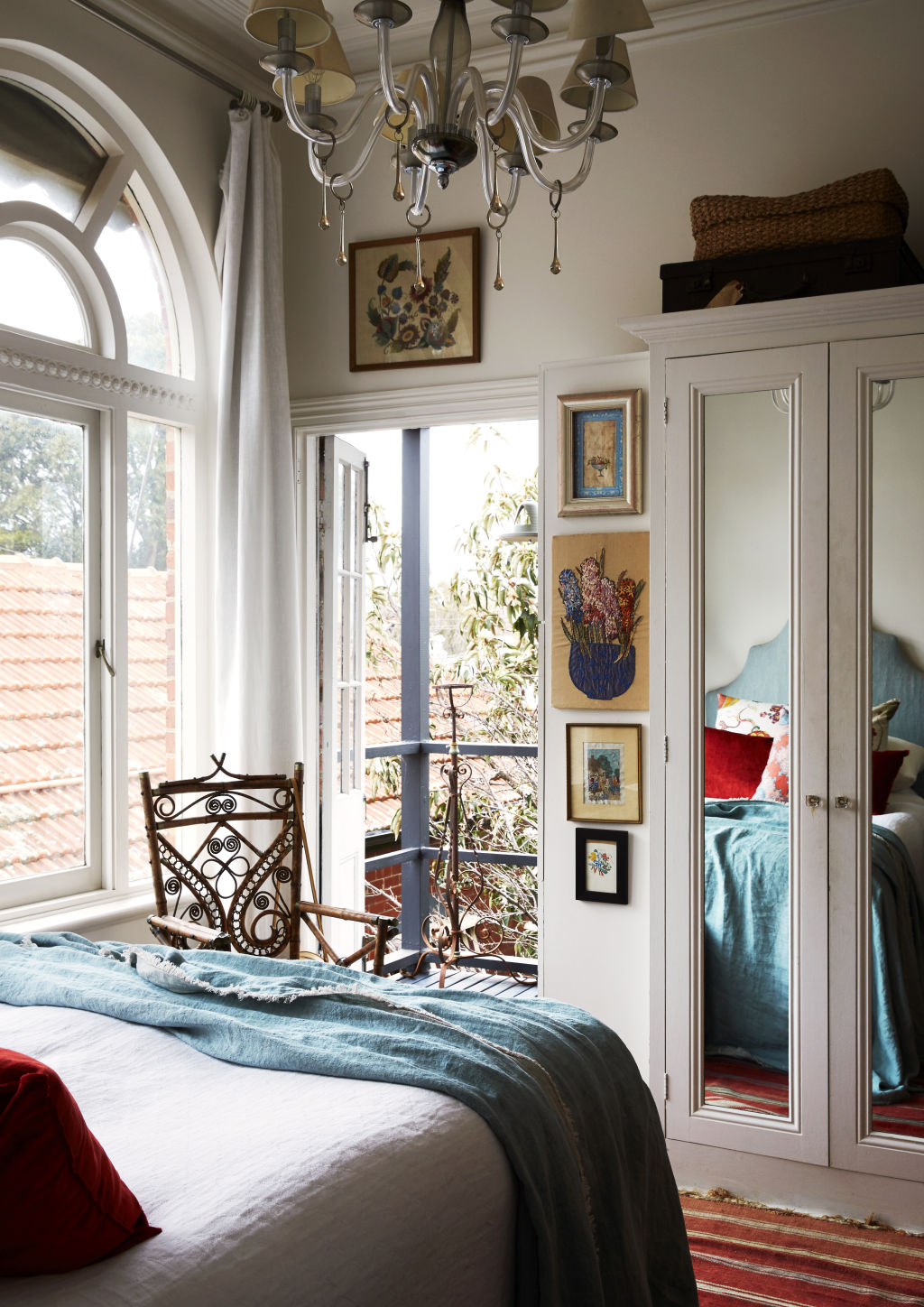 The bedroom. Old embroideries by Tigger’s grandmother, her mother, and Tigger herself. An antique bamboo chair from Geoffrey Hatty. Styling: Annie Portelli. Photo: Caitlin Mills