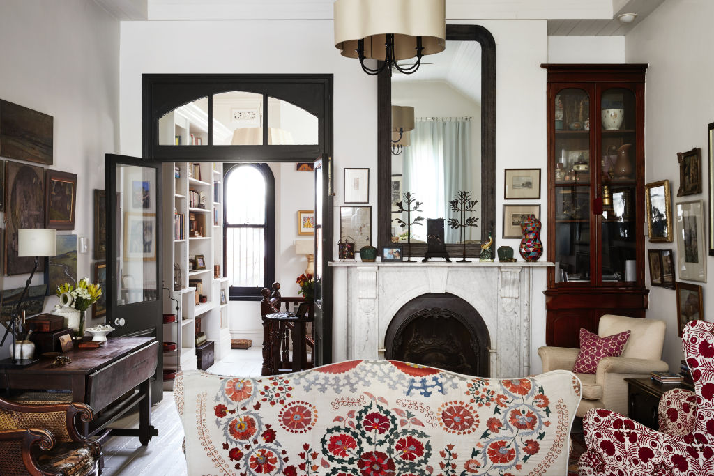 The living room. Sofa covered in Suzani purchased in Istanbul. Chair covered in Penny Morrison Arabella Red. Dulux Natural White is used on the walls. Styling: Annie Portelli. Photo: Caitlin Mills