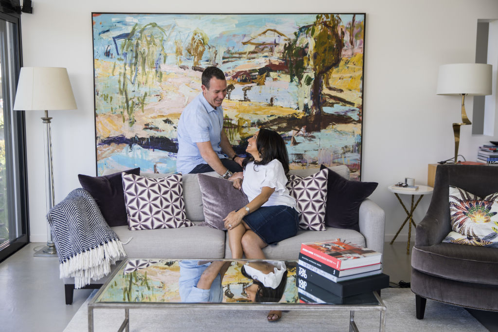 Piers, Nirmal and Frankie in front of a Craig Waddell artwork at their Alex Popov-designed home in Mosman. Photo: Anna Kucera