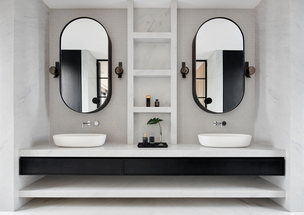 When choosing multiple mirrors for a space, look for a similar shape and finish. Photo: Jack Lovel