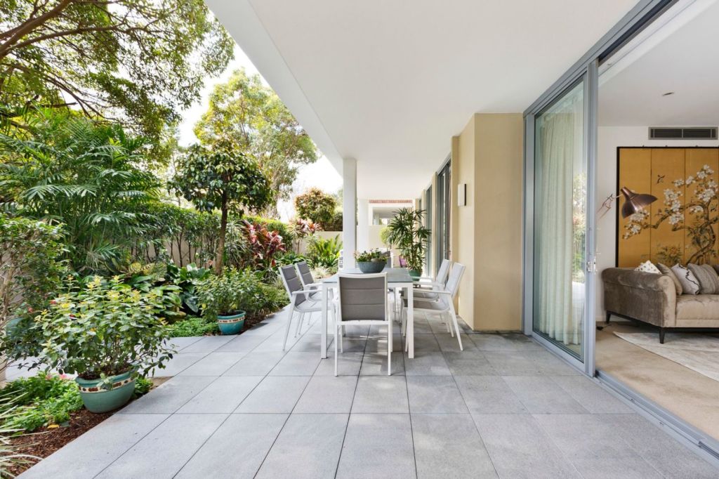 Expansive courtyards and sliding doors create an extended living space outdoors.