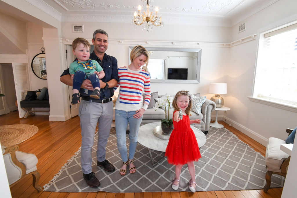 Sam Cutting and Colette Webber, pictured with children Reggie and Winnie in their Coogee apartment, are among more than 700 vendors scheduled to go to auction on Saturday. Photo: Peter Rae