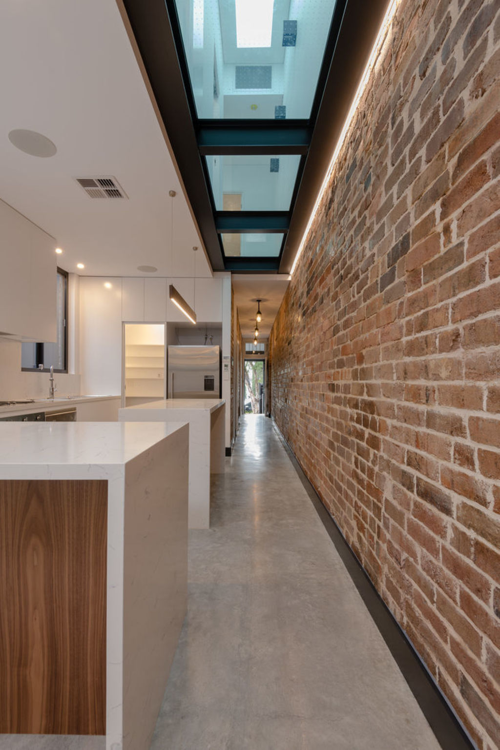 A glass floor on an upper level combines with skylights to bring light into this Bondi terrace. Photo: Home Mend Australia