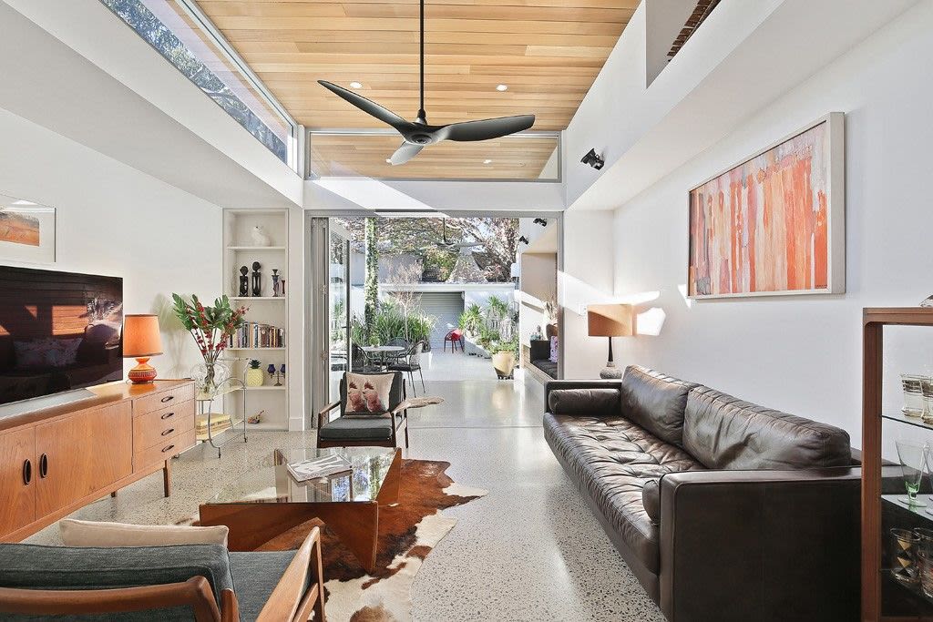 Clerestory windows and glazed rear doors boost natural light int his open plan living area in Darlington. Photo: Home Mend Australia