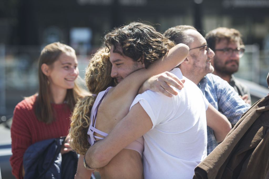 Joel Kuperholz embraces family after buying the townhouse.  Photo: Stephen McKenzie