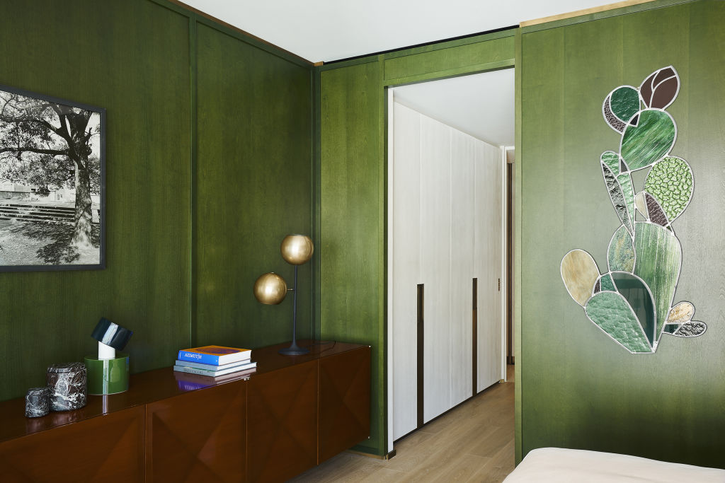 Green waxed timber panels line the walls of the apartment's luxurious main bedroom. Photo: Claire Israel