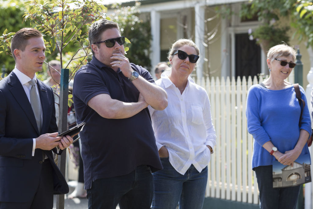 Mr Manolitsas (left) chats with an underbidder during the auction.  Photo: Stephen McKenzie