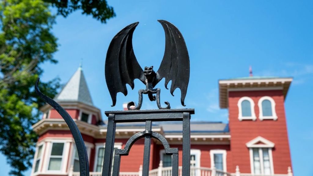 Horror fans pilgrimage to pose in front of the wrought-iron gates. Spooky bats, reptiles, and spiders guard the manor. Photo: iStock