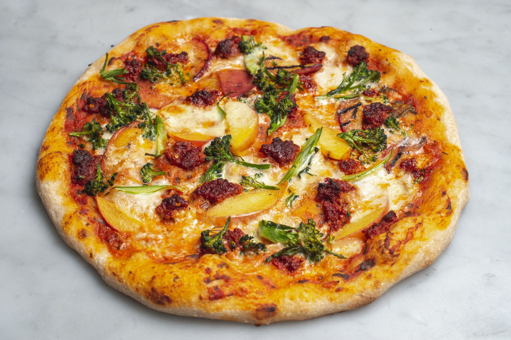 ‘nduja, burrata, charred peach &amp; broccoli pizza at Rustica, South Yarra. Photo: Supplied.