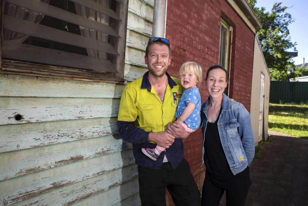 Carisse Matthews and Drew Bowles and daughter Luna outside the home they plan to fix up in Clifton Hill. Photo: Stephen McKenzie