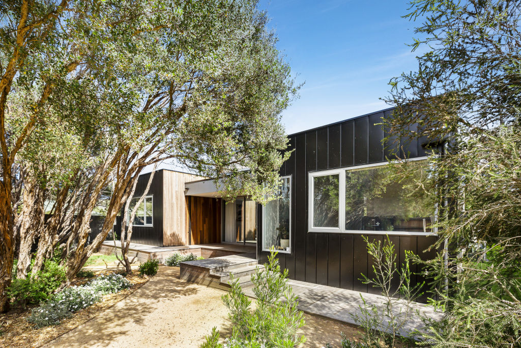 The circular grove that sits perfectly against the boxy black and timber facade. Photo: Jellis Craig.