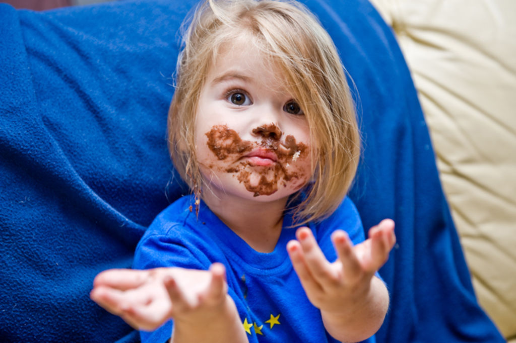 When sticky fingers have marked your clothes or table linens, start by removing as much of the dry, embedded chocolate stain as possible. Photo: iStock