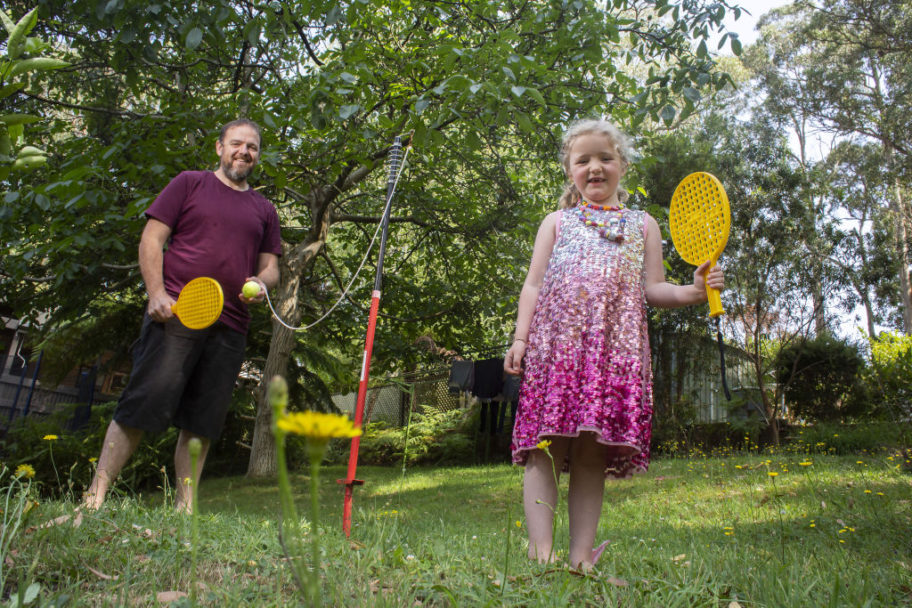 Grant and Elodie Healey play a bit of totem-tennis in their Upwey backyard.  Photo: Stephen McKenzie