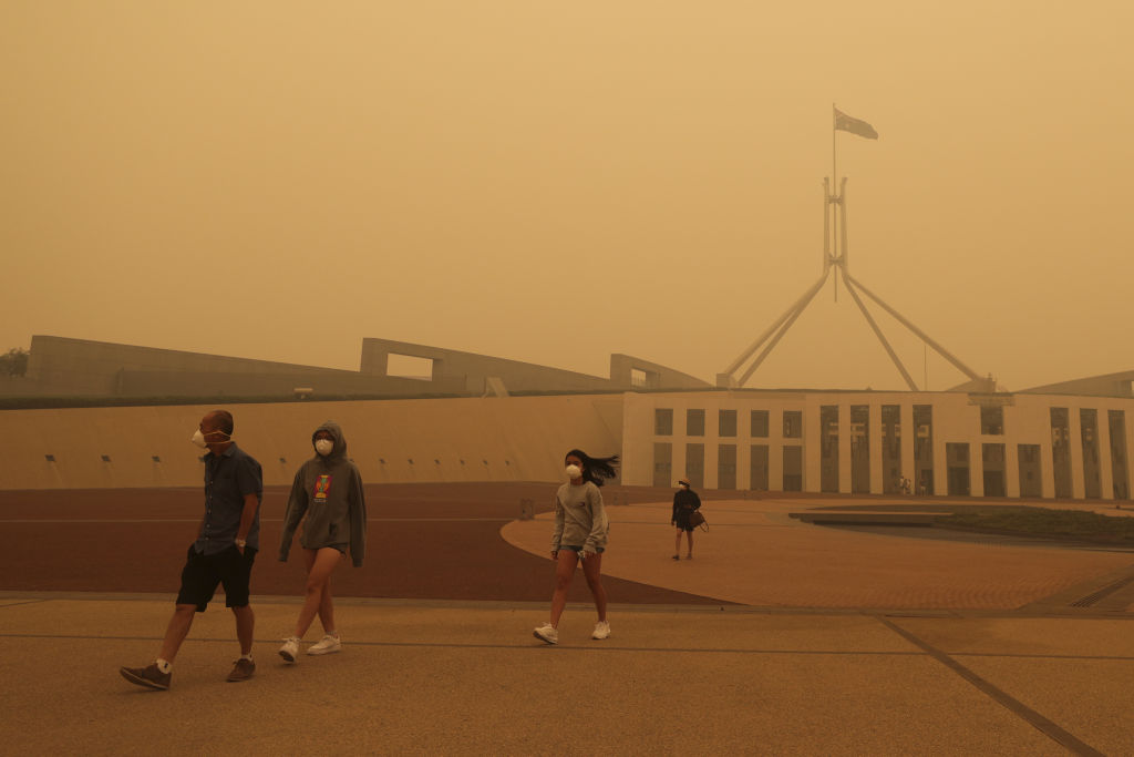 Visitors to Parliament House this month wearing face masks. Photo: Alex Ellinghausen