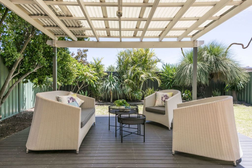 It features a covered deck and enclosed carport. Photo: One Residential