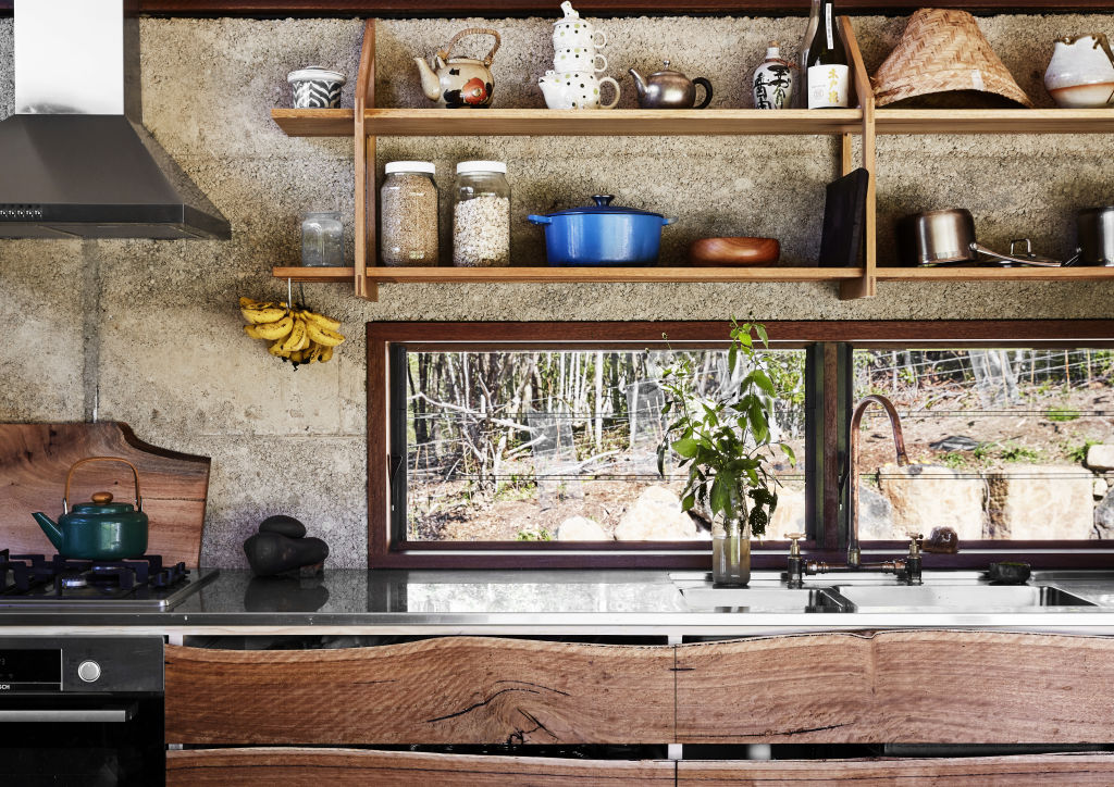 The kitchen, with all joinery built by Sam and Zana from local blackbutt timber, and hoop pine plywood offcuts leftover from building the ceiling. The slatted bottom shelf above the sink works as a draining rack. Styling: Annie Portelli. Photo: Caitlin Mills