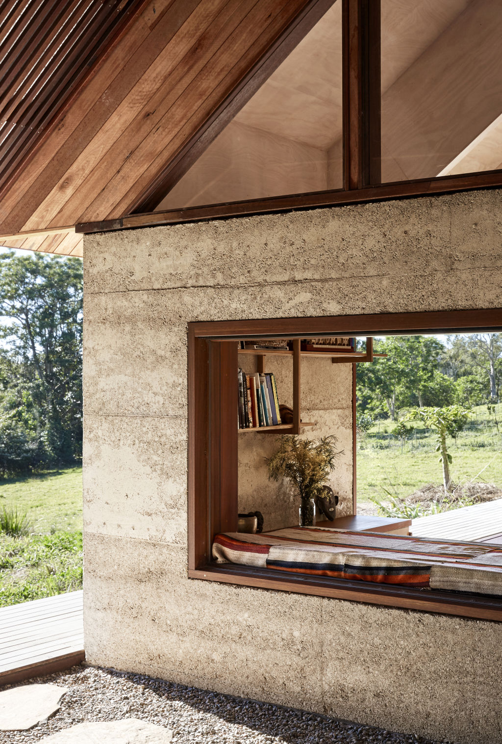 A window nook daybed connects the indoor living room to the outdoor living room. Styling: Annie Portelli. Photo: Caitlin Mills