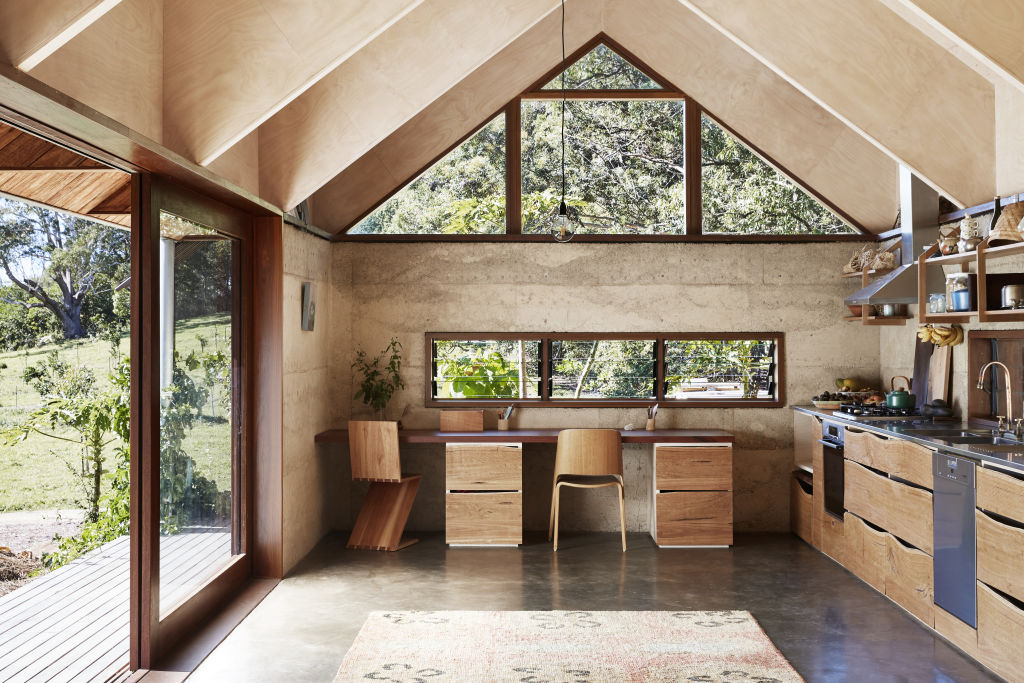 The kitchen cupboard faces in the living pavilion were made by Sam & Zana from one slab of blackbutt timber. Styling: Annie Portelli. Photo: Caitlin Mills