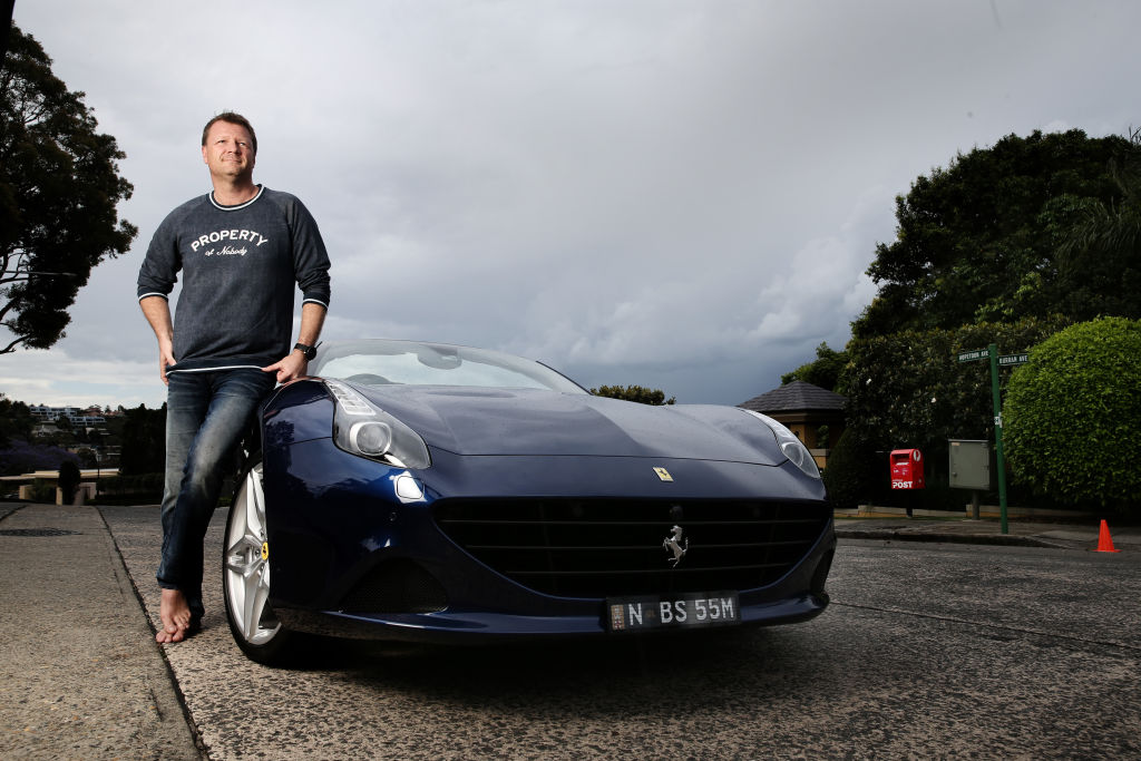 Brett Whitford and his Ferrari near the Mosman home that sold at the weekend. Photo: Louise Kennerley
