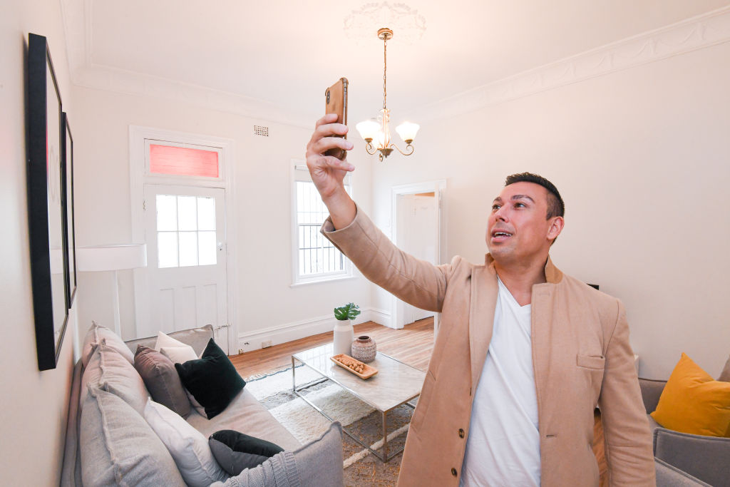 Ray White agent Ercan Ersan conducting a Facebook Live inspection for a client on Saturday. Photo: Peter Rae