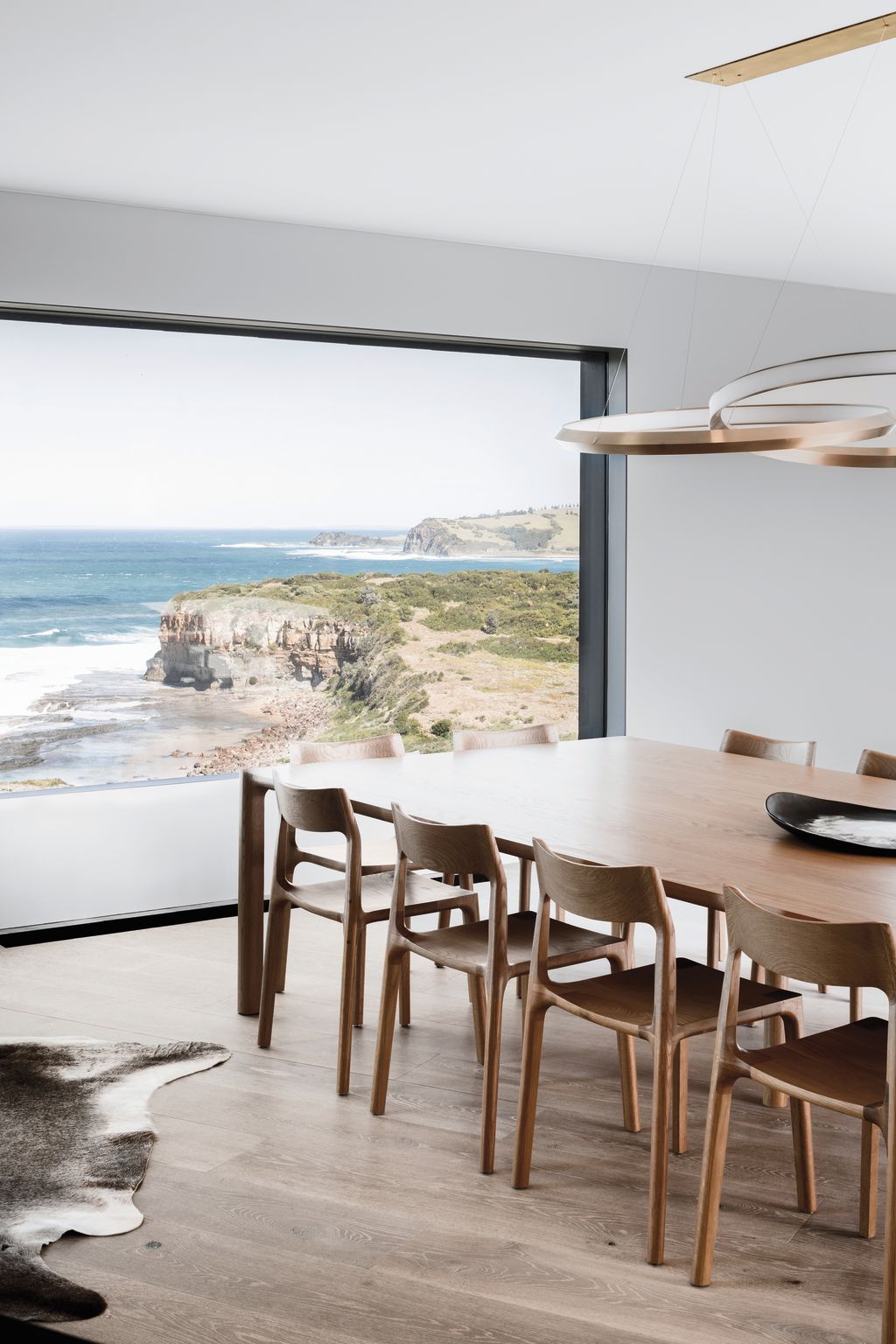 Living room windows frame spectacular scenery.  Photo: Tom Blachford and Kate Ballis. Architecture: Atelier Andy Carson