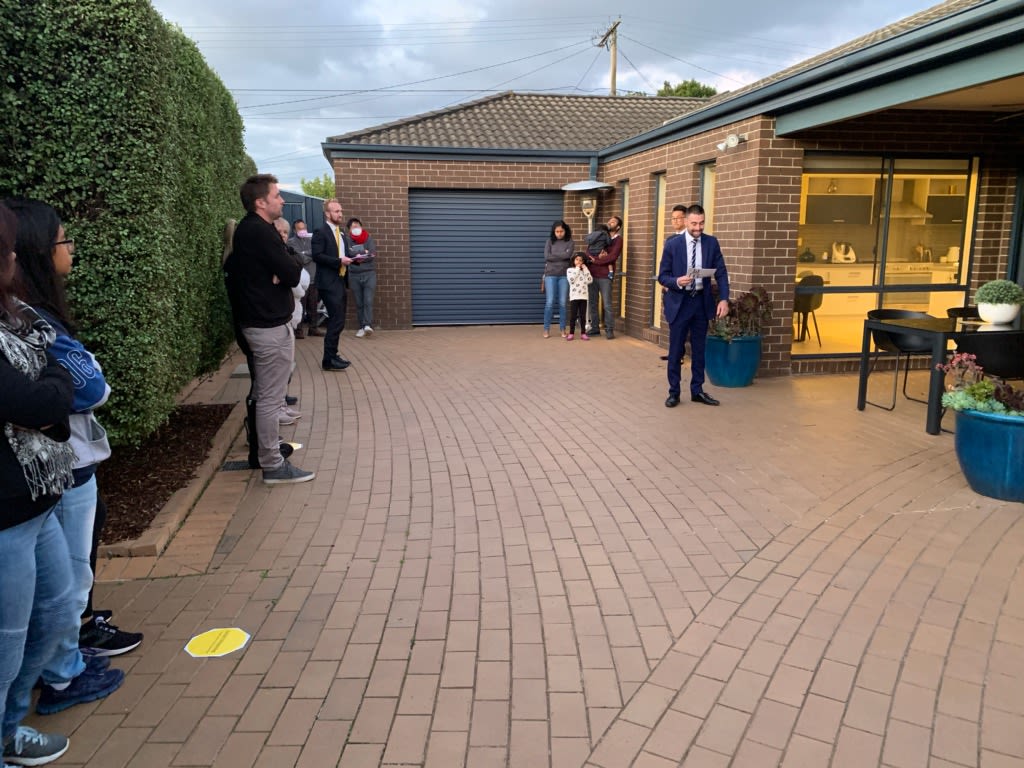 Bidders observe social distancing at the Ferntree Gully auction. Photo: Ray White Ferntree Gully