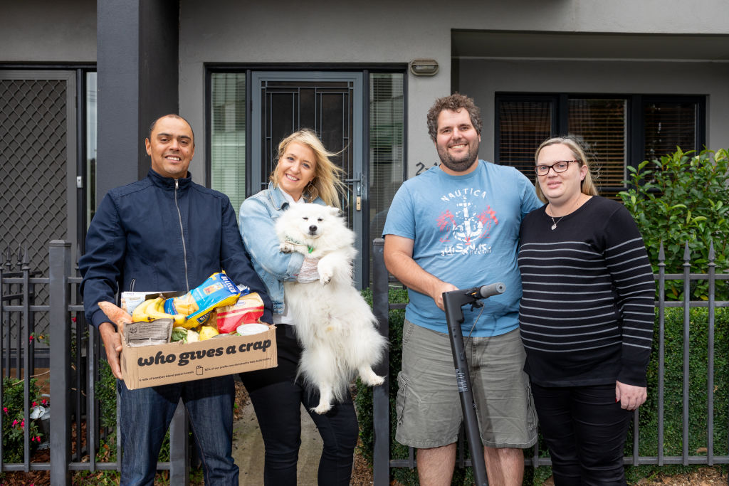 Cass Spong (holding her dog) with her neighbours Shelton (left), Adam Promnitz and his wife. Photo: Greg Briggs