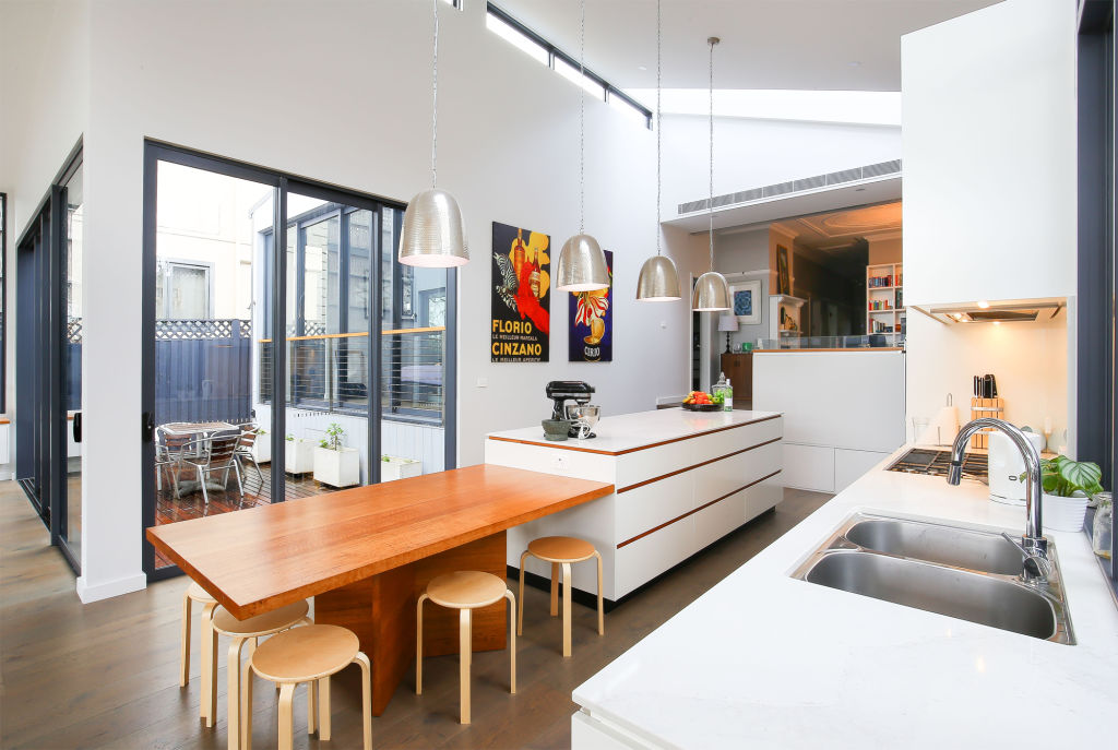 Pendant lighting in the kitchen acts as a functional statement piece at Earlwood House by NSStudio.