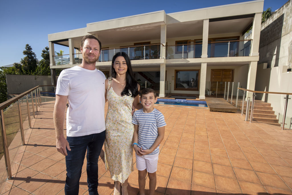 Joe, Brooke and Kadyn Crunkhorn are selling their Holland Park West home via auction. Photo: Glenn Hunt